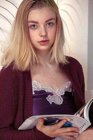 Blond-haired teen in a purple nightie flashing her teen pussy for you